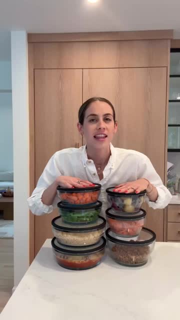 Creator with stacks of filled food containers